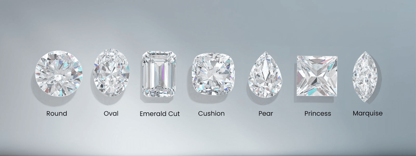 Various diamond shapes arranged on a white surface showing round, oval, emerald and pear cuts